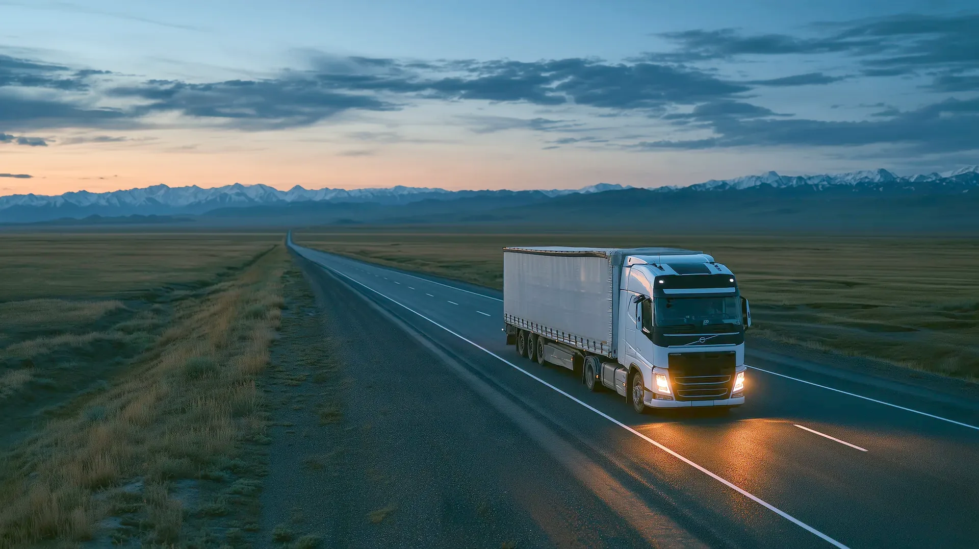 Truck on a highway across the steppe towards Central Asia at dusk